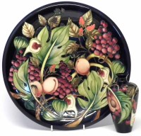 Lot 292 - Moorcroft charger and a small vase, decorated