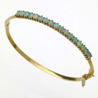 Lot 353 - 9ct gold and opal hinged bangle