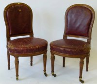 Lot 569 - Pair oak reduced leather library chairs.