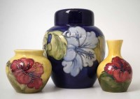 Lot 218 - Moorcroft Hibiscus ginger jar and two vases.