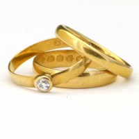 Lot 188 - Three 22ct gold wedding rings, one dressed with a