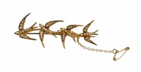 Lot 214 - 15ct yellow gold and seed pearl set swallow motif brooch