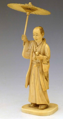 Lot 221 - Japanese ivory okimono of a samurai with umbrella