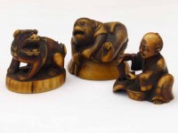 Lot 227 - Three stained ivory netsukes of a monkey, a lion