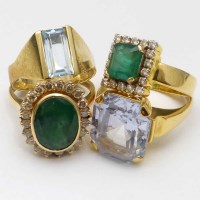 Lot 329 - Two emerald rings and two others.