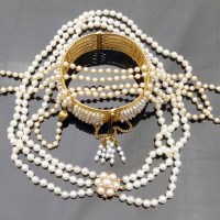 Lot 333 - Gold and pearl bangle and two pearl necklaces.