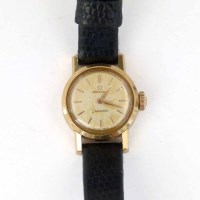 Lot 355 - Lady's Omega 18K gold wrist watch on leather