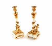 Lot 21 - A pair of French marble and ormolu mounted marble candlesticks.