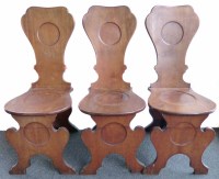 Lot 704 - Three George III mahogany hall chairs