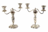 Lot 180 - Pair of Regency style small silver double-stemmed candelabras