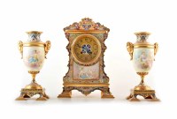 Lot 461 - A late 19th century brass and champlevé French mantel clock and garnitures.
