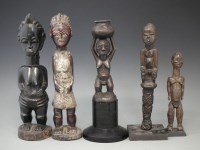 Lot 34 - Four figures and a fly wisk or wand, carved in Bangwa, Luba, Baule, and Lobi styles, the tallest measures 36cm high