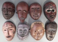 Lot 59 - Eight African masks carved in various tribal