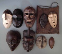 Lot 64 - Nine African masks carved in various tribal