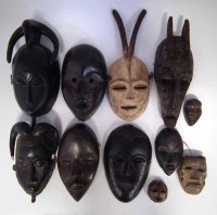 Lot 79 - Eleven African masks carved in various tribal
