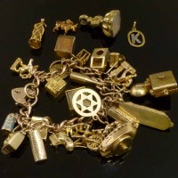 Lot 207 - 9ct gold charm bracelet and four loose charms