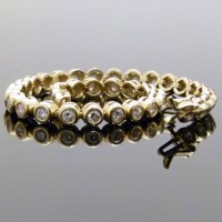 Lot 209 - 14k gold line bracelet set with diamonds