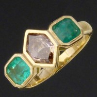 Lot 222 - Emerald and fancy diamond three-stone 750 gold