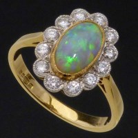 Lot 226 - Opal and diamond oval cluster ring