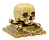 Lot 24 - Brass inwkell skull and cross bones.