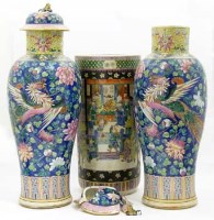 Lot 498 - Pair of tall famille rose vases and covers and a famille noir stick bin, 19th / 20th century (3) (damage).