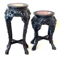 Lot 606 - Two similar Chinese hardwood vase tables both with an inset marble top