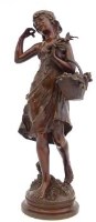 Lot 10 - Patinated bronze standing girl.