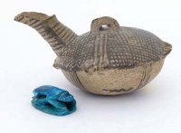 Lot 14 - Cypriot oil lamp and a turquoise scarab.