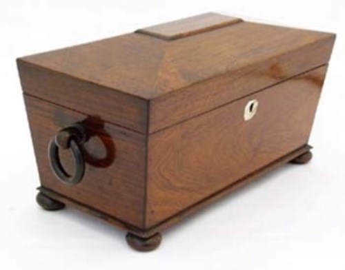 Lot 29 - Rosewood sarcophagus tea caddy with ring handles.