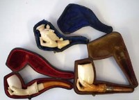 Lot 34 - Three Meerschaum pipes  each carved with a hand