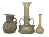 Lot 149 - Three early glass vases probably Roman.