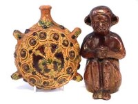 Lot 179 - Stoneware pottery model of a monkey, also a Slipware Costrel
