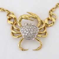 Lot 316 - Gold and diamond crab pendant.