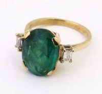Lot 360 - 9ct gold emerald ring with baguette diamonds either