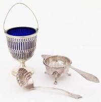 Lot 200 - Silver tea strainer and a sugar basket and spoon.