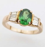 Lot 242 - Green garnet and diamond ring, the coloured oval
