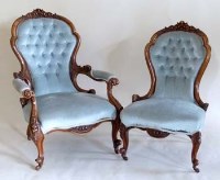 Lot 535 - A pair of Victorian walnut lady and gentleman’s spoon back easy chairs