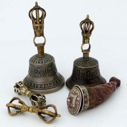 Lot 166 - Two Tibetan cast bi-metal hand bells, two dorjes, powder flask