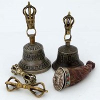 Lot 166 - Two Tibetan cast bi-metal hand bells, two dorjes, powder flask