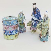 Lot 230 - Three Chinese figures of immortals; four stacking rice bowls and a pair of yellow vases.