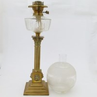 Lot 20 - Brass Corinthian column table oil lamp with frost shade and chimney.