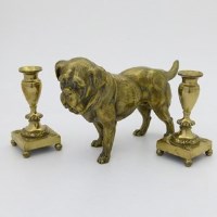 Lot 27 - Brass dog and a pair of candlesticks.