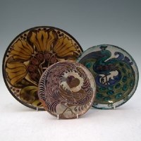 Lot 140 - Three art pottery chargers