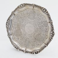 Lot 207 - Silver salver supported on three feet.