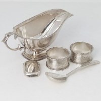 Lot 208 - Silver sauce boat, two napkin rings, vestas case and spoon.