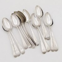 Lot 214 - Sixteen Old English silver table spoons and a fiddle pattern table spoon, 34oz, 9dwt in total (17).