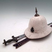 Lot 101 - Straight bladed tulwar and a pith helmet with