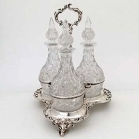 Lot 269 - Victorian silver three-bottle decanter stand.