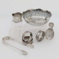 Lot 277 - Pierced bowl, tongs, four napkin rings, caddy