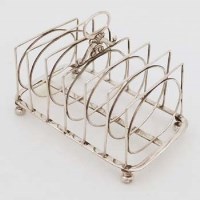 Lot 335 - George III silver wire work seven bar toast rack